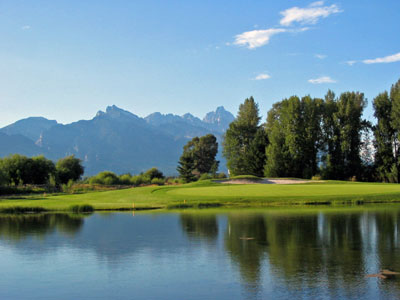 The Tetons reflect off the pond fronting the 13th green at JHG&TC