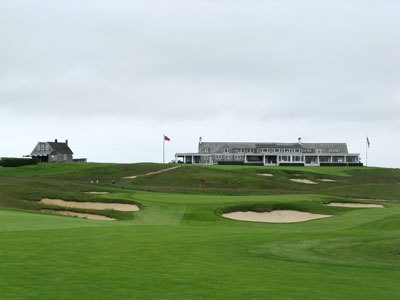 The classic clubhouse rests in the distance behind the 16th green